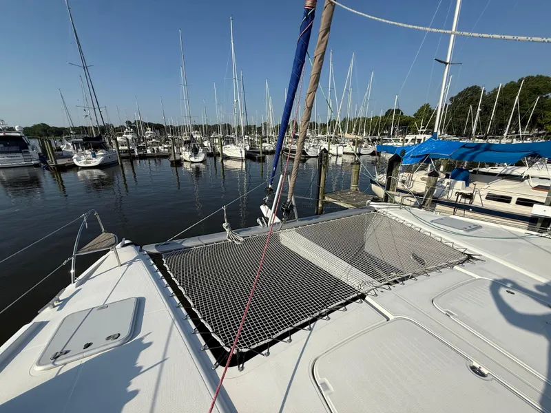 Slide: The Image of 2015 Fountaine Pajot Helia 44 catamaran docked in a marina with other sailboats. - 16