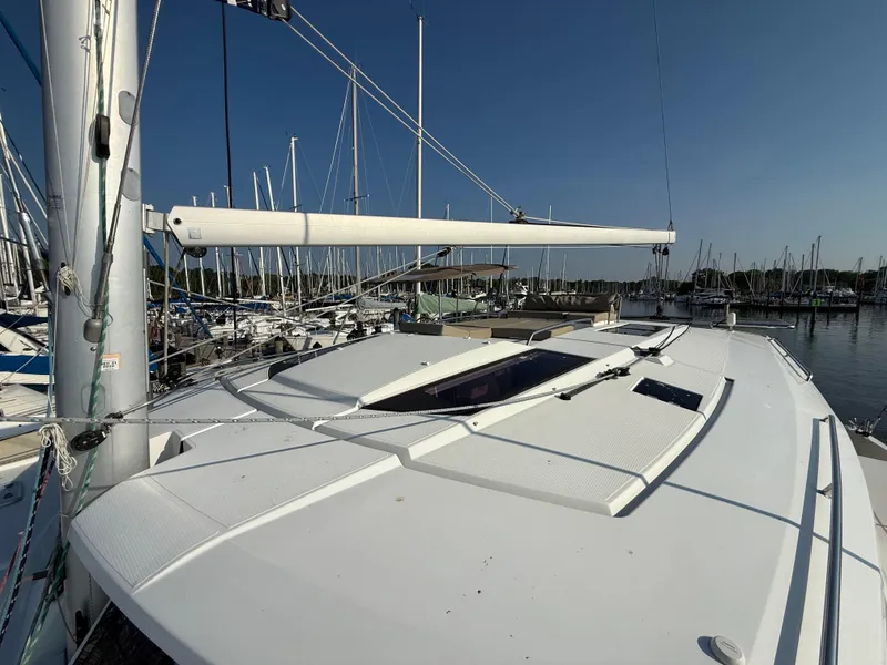 Slide: The Image of 2015 Fountaine Pajot Helia 44 catamaran docked at marina, clear sky background. - 17