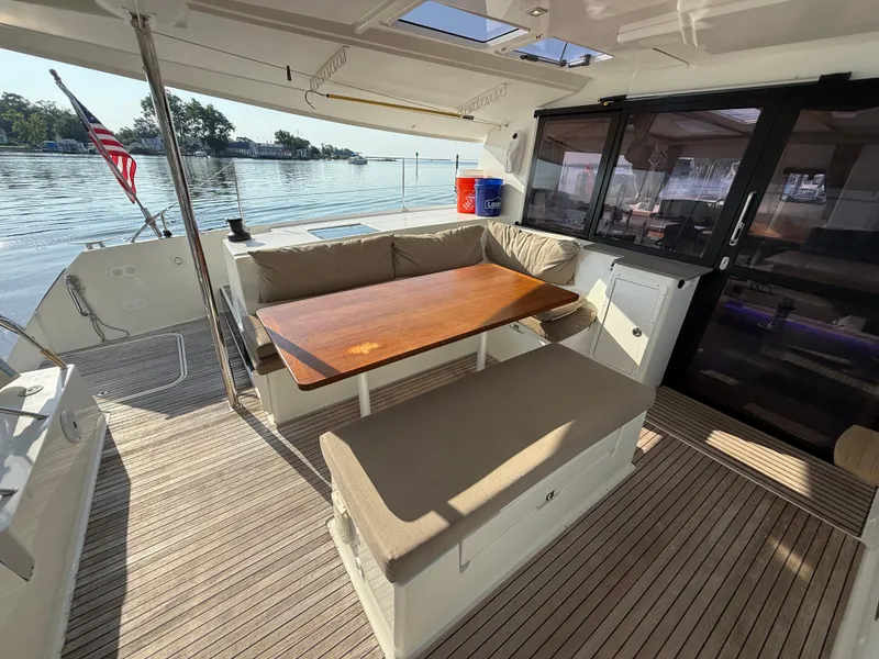 Slide: The Image of Spacious deck of 2015 Fountaine Pajot Helia 44 catamaran with seating and table. - 21