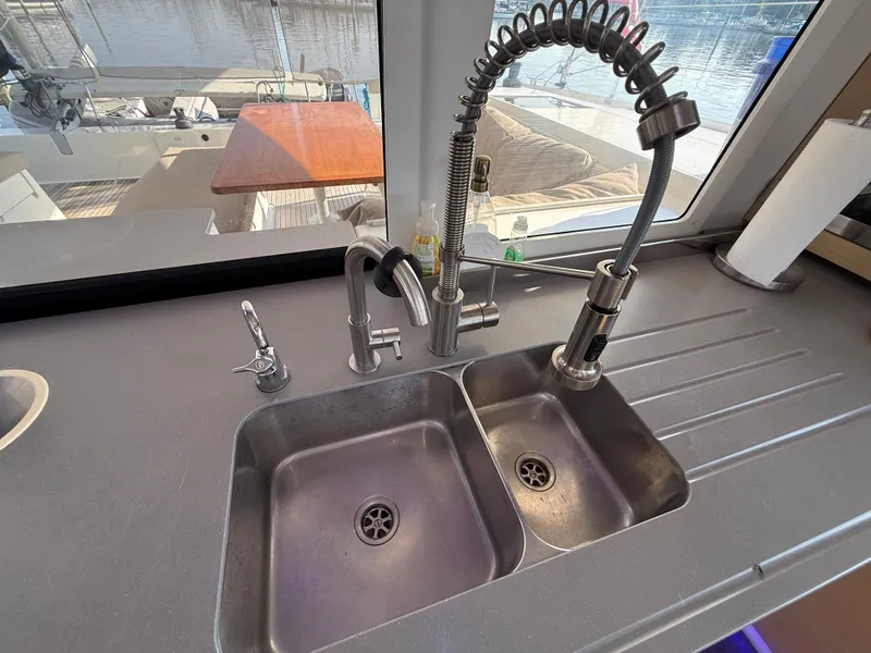 Slide: The Image of Modern kitchen sink with dual basins and flexible faucet on Fountaine Pajot Helia 44 yacht. - 29