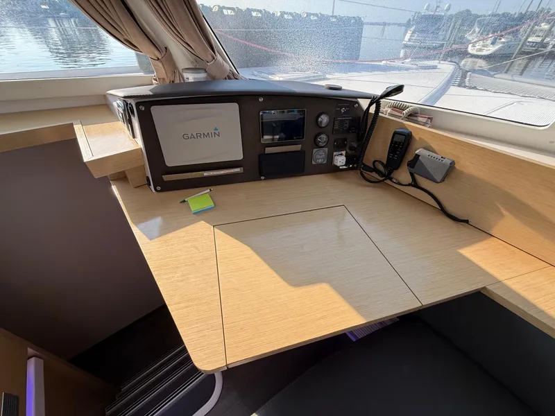 Slide: The Image of Navigation station on 2015 Fountaine Pajot Helia 44 catamaran with Garmin equipment and wooden desk. - 31