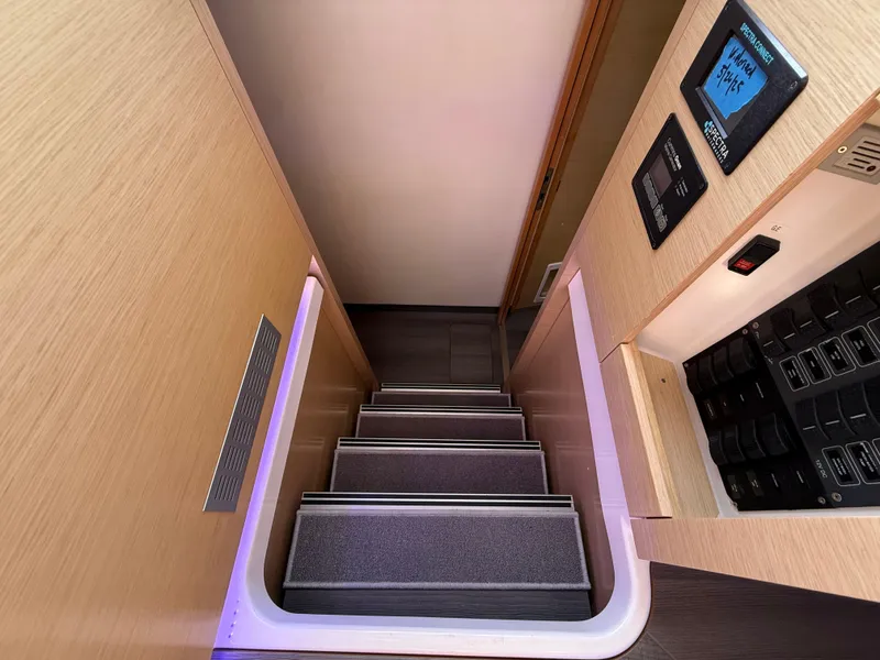 Slide: The Image of Interior stairs of 2015 Fountaine Pajot Helia 44 catamaran, featuring modern design and control panels. - 32