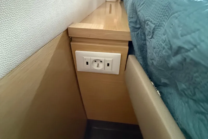 Slide: The Image of Power outlet beside bed in 2015 Fountaine Pajot Helia 44 yacht interior. - 36