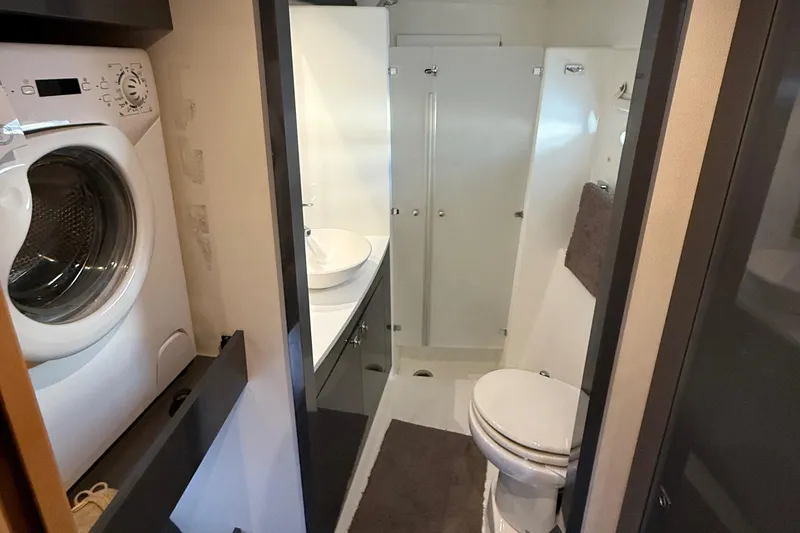 Slide: The Image of Bathroom interior of 2015 Fountaine Pajot Helia 44 with washer, sink, and toilet. - 38
