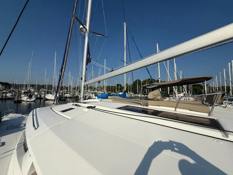 Slide: The Image of 2015 Fountaine Pajot Helia 44 catamaran docked in a marina under clear blue skies. - 8