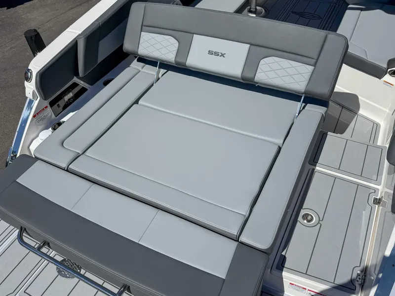 Slide: The Image of 2025 Chaparral 2870 SSX boat with gray cushioned seating and SSX logo. - 11