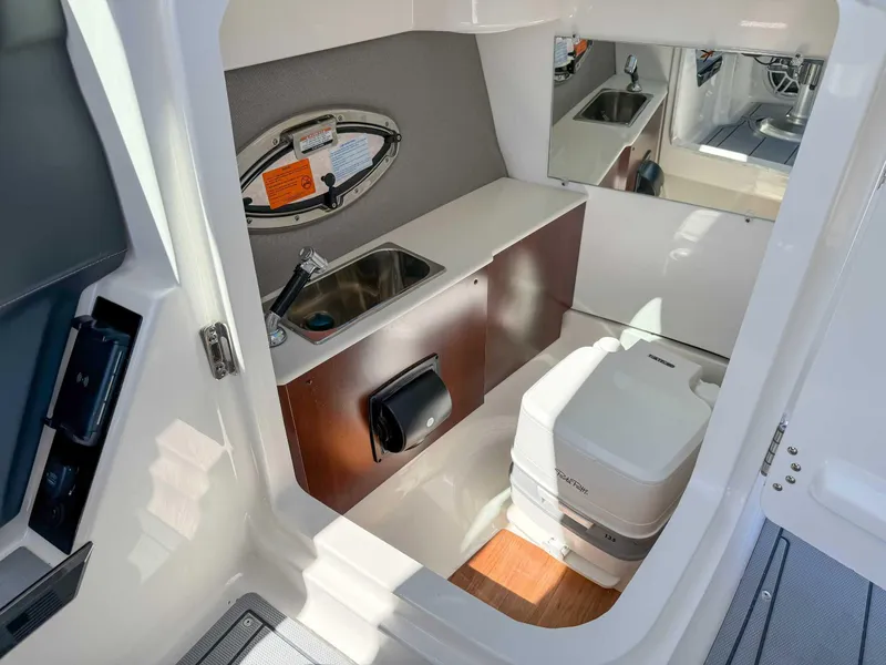 Slide: The Image of 2025 Chaparral 2870 SSX boat interior with sink and portable toilet. - 18