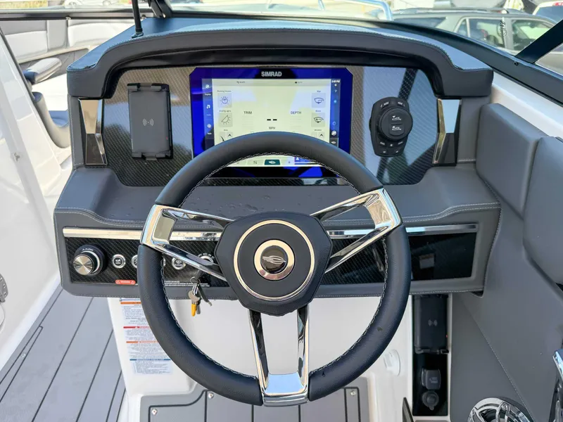Slide: The Image of Steering wheel and dashboard of 2025 Chaparral 2870 SSX boat with modern controls. - 19