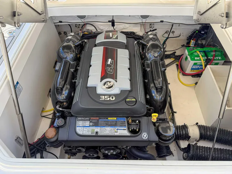 Slide: The Image of Engine compartment of 2025 Chaparral 2870 SSX with Mercury 350 engine and battery. - 23