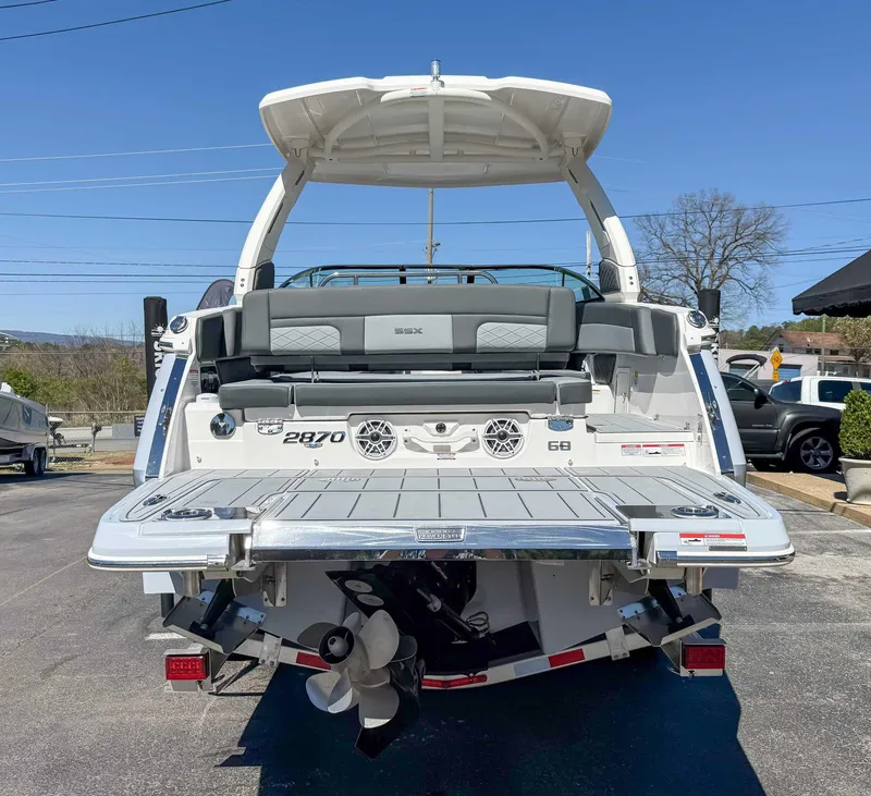Slide: The Image of 2025 Chaparral 2870 SSX boat rear view with swim platform and seating. - 9