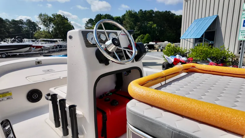 Slide: The Image of 2025 Carolina Skiff E18 JVX CC boat interior with steering wheel and dashboard. - 4