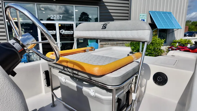 Slide: The Image of 2025 Carolina Skiff E18 JVX CC boat helm with cushioned seat and steering wheel. - 5