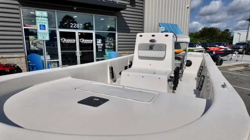 Slide: The Image of 2025 Carolina Skiff E18 JVX CC boat displayed outside dealership. - 7