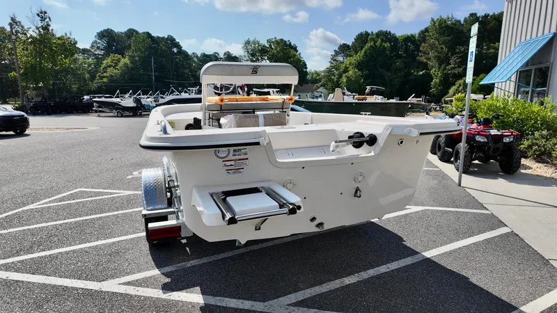 Slide: The Image of 2025 Carolina Skiff E18 JVX CC boat on trailer in parking lot. - 9