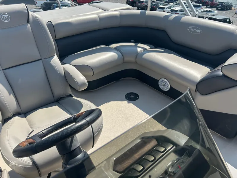 Slide: The Image of Luxurious seating on 2014 Premier 220 SunSation boat with steering wheel and controls. - 11