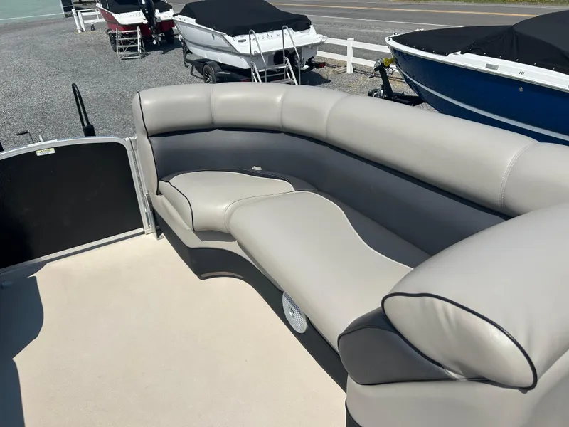 Slide: The Image of 2014 Premier 220 SunSation boat interior with gray cushioned seating. - 17