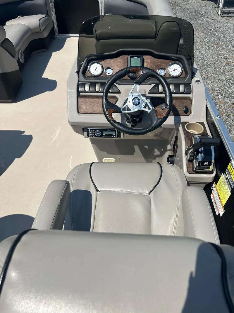 Slide: The Image of 2014 Premier 220 SunSation boat dashboard with steering wheel and controls. - 20