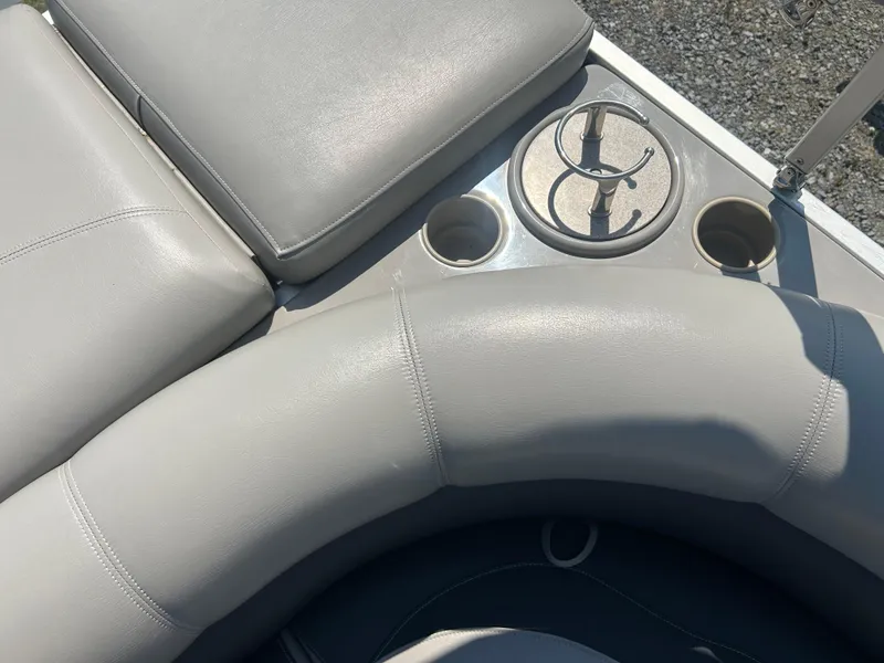 Slide: The Image of 2014 Premier 220 SunSation boat interior with gray seating and cup holders. - 24