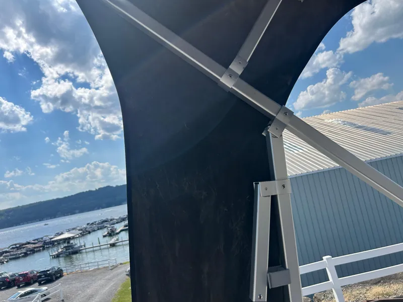 Slide: The Image of View from a 2014 Premier 220 SunSation boat, overlooking a marina and blue sky. - 26