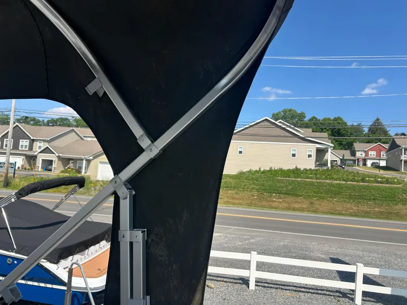 Slide: The Image of 2014 Premier 220 SunSation boat canopy frame with suburban neighborhood background. - 27