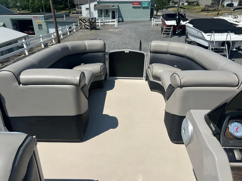 Slide: The Image of 2014 Premier 220 SunSation pontoon boat interior with gray seating and open deck. - 28