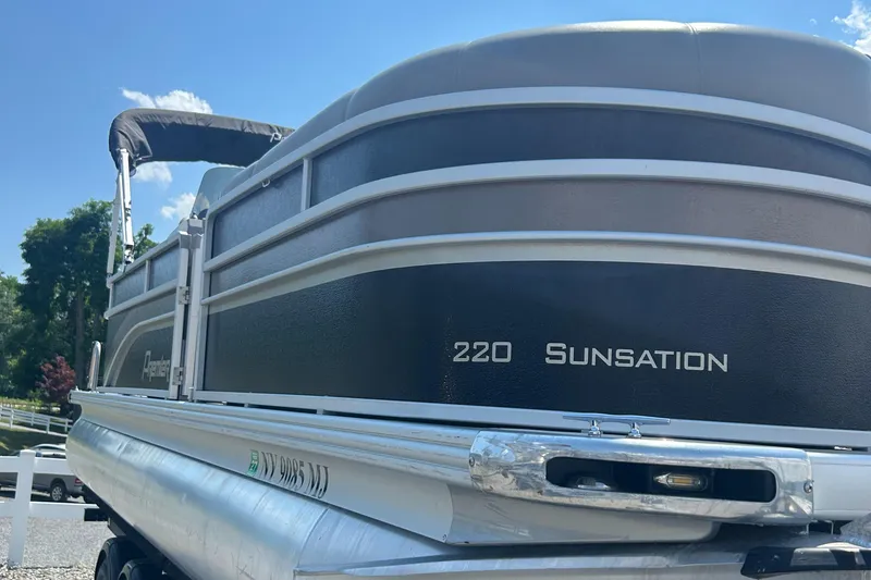 Slide: The Image of 2014 Premier 220 SunSation pontoon boat under a clear blue sky. - 3