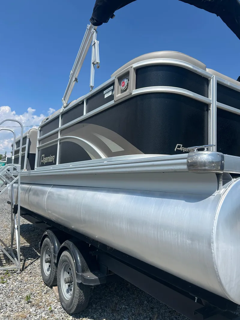 Slide: The Image of 2014 Premier 220 SunSation pontoon boat on trailer under clear blue sky. - 31