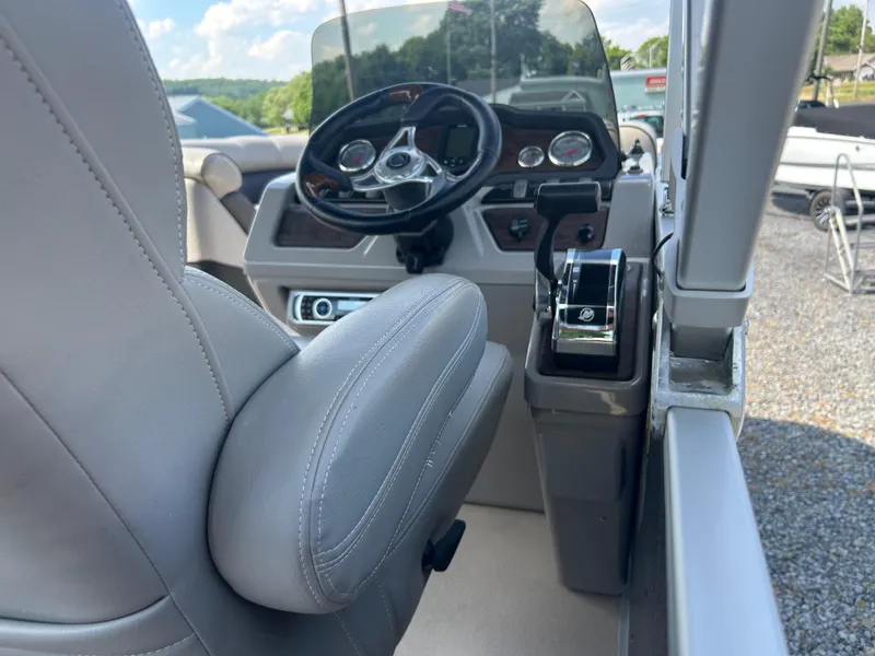 Slide: The Image of Interior of 2014 Premier 220 SunSation boat showing steering wheel and controls. - 4