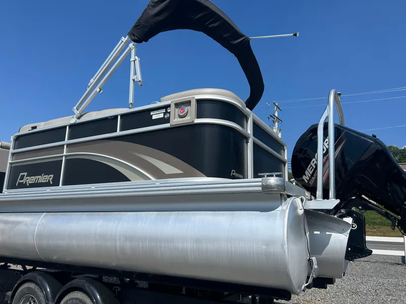 Slide: The Image of 2014 Premier 220 SunSation pontoon boat with Mercury outboard motor, parked on trailer. - 7