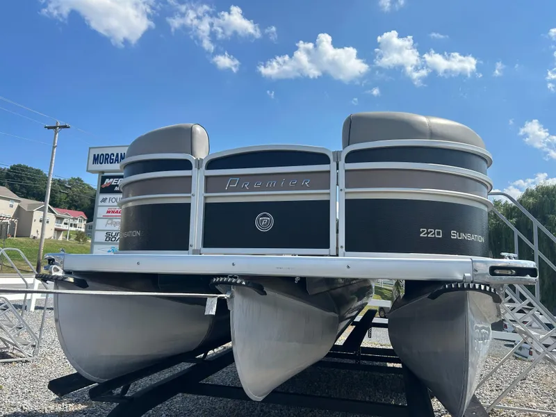 Slide: The Image of 2014 Premier 220 SunSation pontoon boat displayed outdoors under a blue sky. - 8