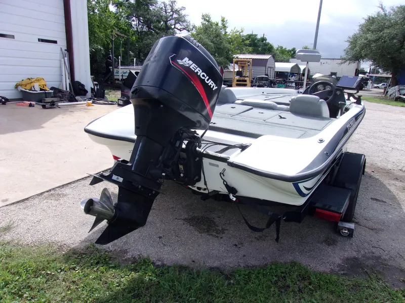 Slide: The Image of 2004 Stratos 275 Pro XL boat with Mercury outboard motor, parked outdoors. - 3