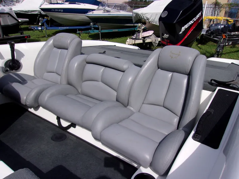 Slide: The Image of 2004 Stratos 275 Pro XL boat interior with gray leather seats and Mercury engine. - 7