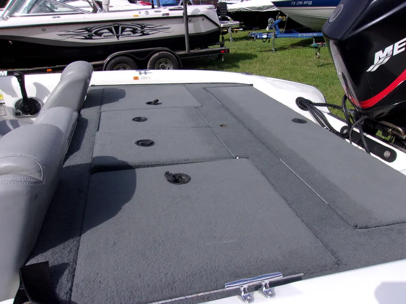 Slide: The Image of 2004 Stratos 275 Pro XL boat deck with gray carpet and Mercury outboard motor. - 8
