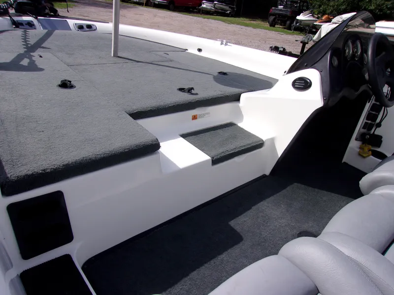 Slide: The Image of 2004 Stratos 275 Pro XL boat interior with carpeted deck and seating area. - 9