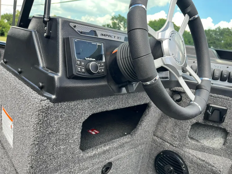 Slide: The Image of 2026 Lund 1775 Impact XS Sport boat dashboard with steering wheel and control panel. - 19