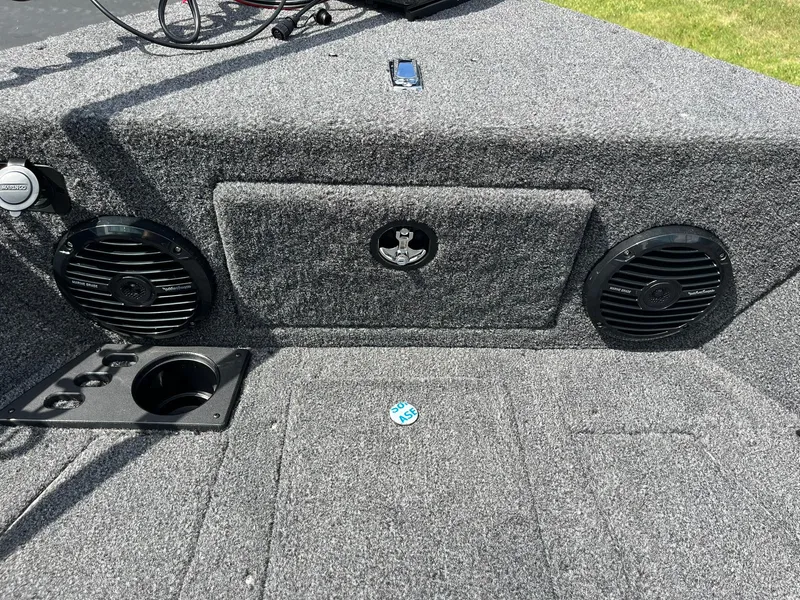 Slide: The Image of 2026 Lund 1775 Impact XS Sport boat interior with speakers and cup holders. - 20