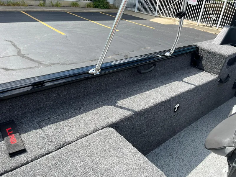 Slide: The Image of 2026 Lund 1775 Impact XS Sport boat interior with gray carpet and seating. - 22