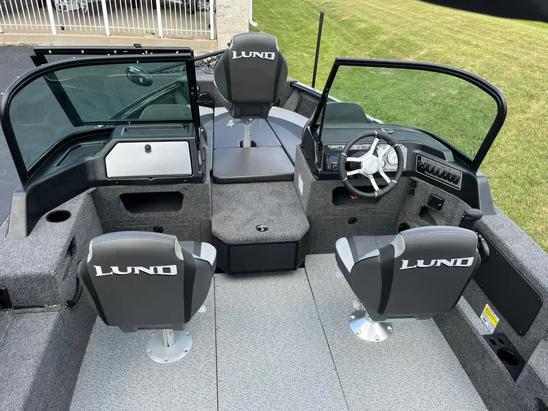 Slide: The Image of 2026 Lund 1775 Impact XS Sport boat interior with seating and steering console. - 6