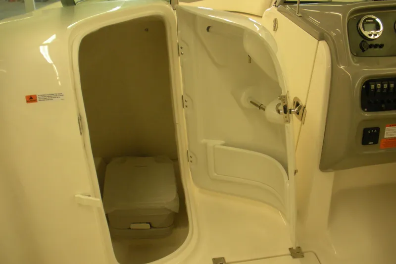 Slide: The Image of 2026 Robalo R207 Dual Console boat interior with open storage compartment. - 10