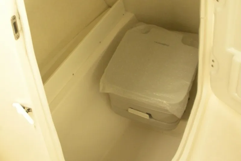 Slide: The Image of 2026 Robalo R207 Dual Console interior storage compartment with portable toilet. - 11