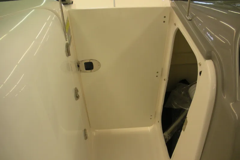Slide: The Image of 2026 Robalo R207 Dual Console storage compartment, open and empty, showcasing interior space. - 12