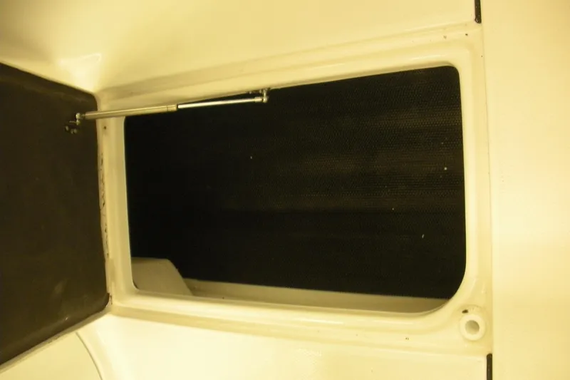 Slide: The Image of 2026 Robalo R207 Dual Console storage compartment with hydraulic support. - 14