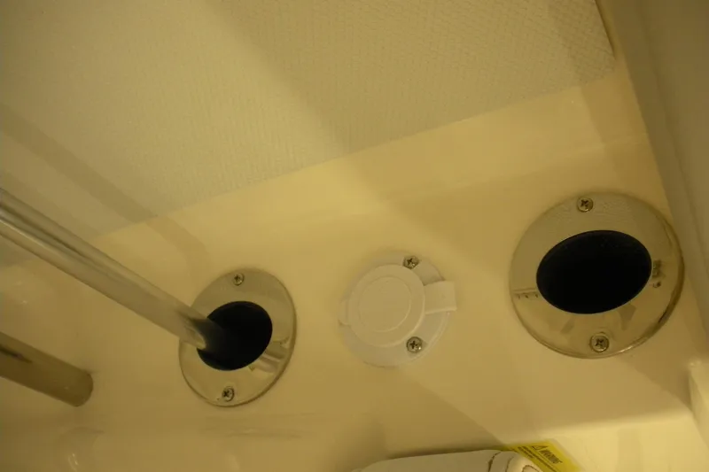 Slide: The Image of 2026 Robalo R207 Dual Console boat interior detail with rod holders and fittings. - 15