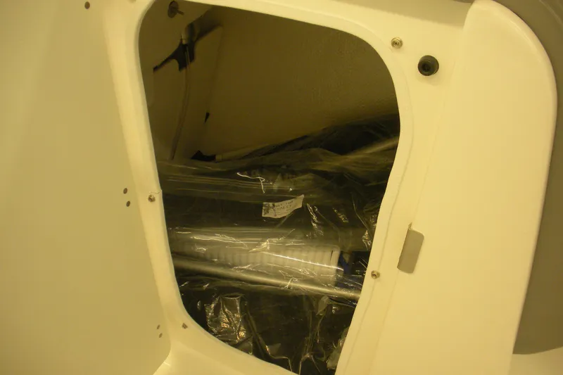 Slide: The Image of Storage compartment of 2026 Robalo R207 Dual Console boat, showing interior details. - 17