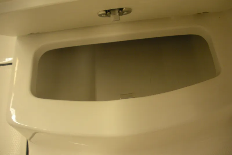 Slide: The Image of 2026 Robalo R207 Dual Console storage compartment interior view. - 18