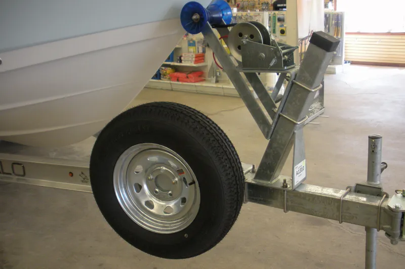 Slide: The Image of Trailer for 2026 Robalo R207 Dual Console boat in a showroom setting. - 20