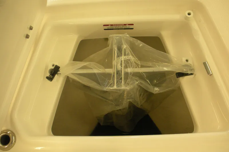 Slide: The Image of 2026 Robalo R207 Dual Console storage compartment with plastic cover. - 3