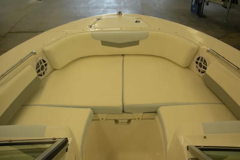 Slide: The Image of 2026 Robalo R207 Dual Console boat interior with cushioned seating and speakers. - 4
