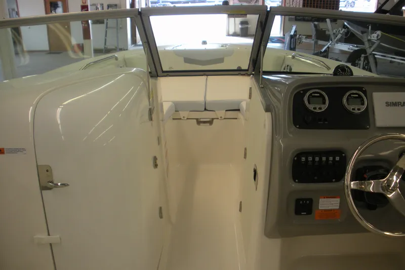 Slide: The Image of 2026 Robalo R207 Dual Console interior with steering wheel and dashboard controls. - 5