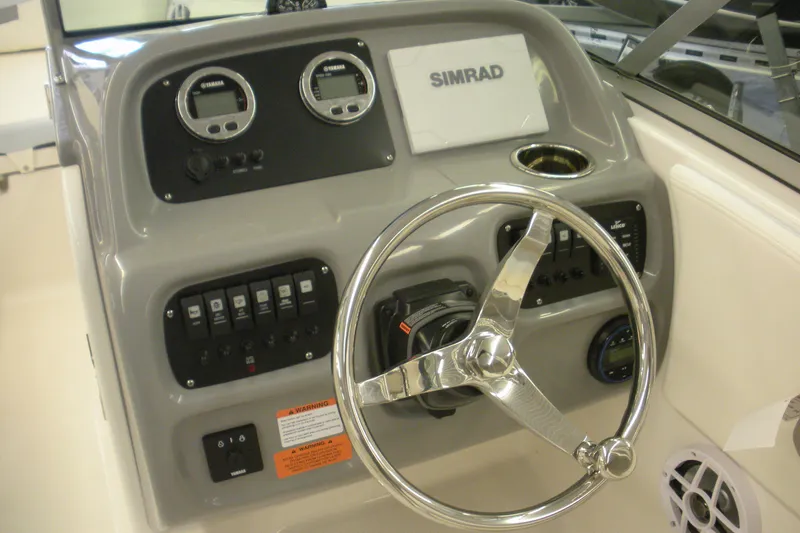 Slide: The Image of 2026 Robalo R207 Dual Console dashboard with steering wheel and control panel. - 6